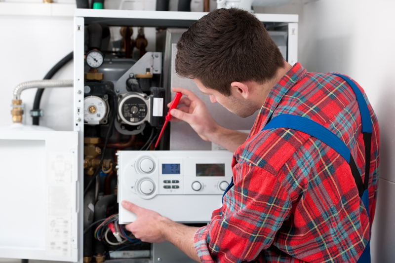Gas Safe engineer working on a boiler in Hampton Hill